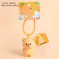 Apricot Butter Bear keychain in silicone finish with yellow spiral strap and bubble accessory - Apricot Small Squeeze With Refill