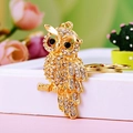 Charming golden owl keychain with sparkling crystals on a soft decorative background - A430 Owl M White
