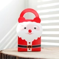 Close-up of a red cartoon Santa Claus gift bag with handle on a wooden surface - Santa Claus Design / 9*6*18cm