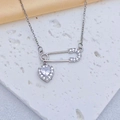 Macro detail of silver safety pin and heart pendant necklace set with clear zircons - Heart Safety Pin Pendant / Silver White