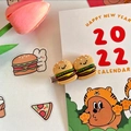 Detail of funny 3D hamburger hair clip with a cute smiley face on a metal duckbill pin - Hamburger