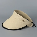 Detail of beige straw sun visor with black trim and elegant gold leaf metal accent - Beige