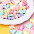 Macro shot of macaron colored heart acrylic beads with pearlescent finish in a ceramic dish - Heart Shape Mixed Colors