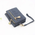 Detail of dark blue bifold wallet with matte finish, dual gold zippers and wrist strap - Short Style / Ink Blue