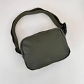 Detailed view of the olive green nylon crossbody waist bag with adjustable buckle strap - 21*15*6cm / Army Green