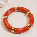 Detail of red marble texture acrylic bamboo tubes and polished gold spacers bracelet - Orange Red