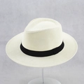 Detail of a beige wide-brimmed straw fedora with a black ribbon band and fine weave texture - 58cm / Cream