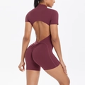Detail showing backless design and ruched lifting effect on burgundy yoga bodysuit - Burgundy