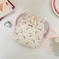 Detailed view of floral drawstring storage bag made of beige cotton linen fabric - Beige