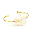 Macro detail of handmade tree of life wire-wrapped opal stone on gold open cuff bracelet - Opal