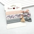 Detailed view of three elastic hair ties with floral patterns and love heart charms - Floral Pendant (9)