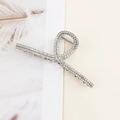 Detail shot of a silver metal hair claw clip with sparkling rhinestones and feather decor - Silver Cross Rhinestone Style
