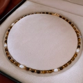 Macro detail of freshwater pearls and brown tiger eye beads on a golden necklace - Necklace-Coffee