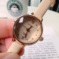 Elegant rose gold quartz watch with beige leather strap for women shown in lifestyle hand setting - Apricot (62955)