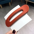 Matte burnt orange claw clip with a hollow rectangular design for elegant styling - Orange