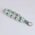 Handmade crochet flower keychain featuring mint green and teal daisy weave with gold ring - Light Green