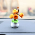 Close-up of handmade orange plush sunflower plant in white pot on car dashboard - Persimmon Pipe Cleaner Potted Plant