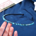 Detailed view of handmade 6mm blue marble crystal beads on a thin black metal headband - 6mm Blue Apatite