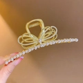 Luxurious gold metal hair claw clip with pearl bow decoration for elegant hairstyles. - Pearl Bow Tie Claw Clip