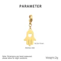 Detail of a gold stainless steel Hamsa Hand pendant with a heart cutout and lobster clasp - 22X15mm Heart Hollow Hamsa Hand Style(KLJ6994-Z) / Gold