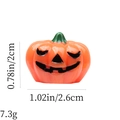 Detail view of orange pumpkin decoration with size 0.78x1.02in and weight 7.3g - Orange Squinting Pumpkin