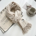 Beige soft cashmere-feel scarf with fringes on white table with lifestyle props - Beige