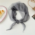 Detail of grey diamond-shaped silk scarf with lace edges and elegant pearl drop accents - Gray
