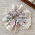 Pink floral fabric scrunchie with white lace trim on a beige textured background - Scrunchie / Pink White Flower Rabbit