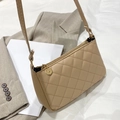 Beige quilted shoulder bag with gold zipper charm styled on a grey blazer - Apricot
