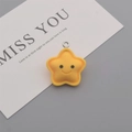 Close-up of yellow smiling star resin charm with silver metal ring for DIY jewelry making - Yellow Smile Star