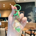 Conch schelp sleutelhanger met groene glitters en acryl afwerking voor tassen - Zeeschelp-Groen