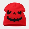 Close-up of red knit beanie featuring a black woven Halloween pumpkin face pattern - Style C Red (Pumpkin Pattern)