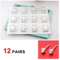 Macro view of 12 pairs of sterile stainless steel ear piercing studs with white rhinestones - Steel Color White Zircon (12 Pairs)