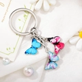 Detail view of colorful enamel butterfly charms on a silver metal keychain with ring - Style 1 M739 (Blue/Pink Butterfly)