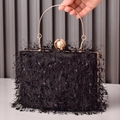 Elegant black feathered evening bag with gold ring handle and pearl clasp detail - Black