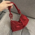 Close-up of red rhinestone evening clutch bag with unique knotted handle design - Standard Size / Burgundy
