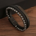 Handmade multi-layer leather braided bracelet with magnetic buckle on dark wood background - Black