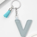 Close-up of light blue PU leather letter V keychain with matching tassel and silver ring - Light Blue-Letter V
