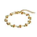 Macro detail of cherry charm bracelet with 14K gold finish and green enamel leaf detail - Gold Yellow