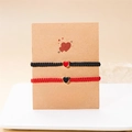 Handmade woven couple bracelets set in black and red with heart pendants on a gift card - Black & Red - Set of 2