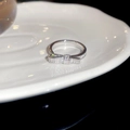 Macro shot of polished silver bow ring with shimmering cubic zirconia on white ceramic - Silver Bowknot Style