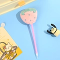 Close-up of pink plush strawberry ballpoint pen with silver dots on blue background - Pink Strawberry