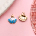 Detailed view of colorful shell enamel charms with striped pattern and gold finish - Lake Blue Enamel Alloy Medium Shell