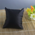 Single black faux leather display pillow for watches and jewelry on a bamboo mat - Black PU Leather 7.6x8.5