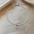 Elegant white pearl choker with pink butterfly pendant and gold finish extender chain - Pink Butterfly Pearl Choker Necklace