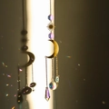 Golden sun and moon suncatcher with multifaceted crystal prisms creating rainbow light - Design No.19