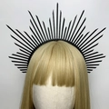 Detail of a black spiked halo crown headpiece worn on a golden blonde wig - Style 5