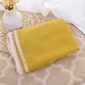 Detail of ginger yellow cotton muslin baby blanket with elegant white lace edge trim - Turmeric