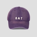 Detailed close-up of washed purple cotton baseball cap with white EAT embroidery - M (56-58cm) / Purple