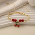 Adjustable woven rope bracelet with gold beads and a red strawberry enamel pendant - Gold Beads Strawberry Pendant (E000444YS)